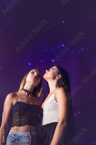 two friends in love against the starry sky