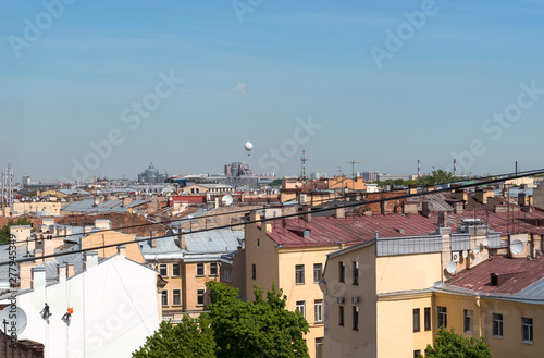 view of St. Petersburg from the roof, the roof of old buildings in the center of the old city, blue sky