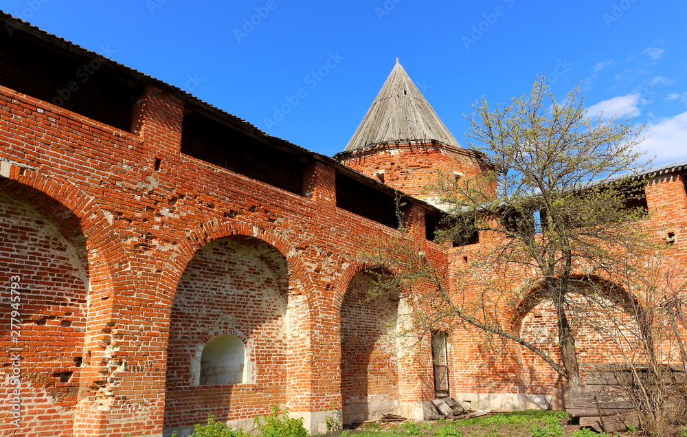 Medieval walls and Arsenal Corner Tower of Zaraysk Kremlin. The inner territory of the Kremlin in spring sunny day. Cultural heritage of the Middle Ages (16th century) in the Moscow region, Russia 