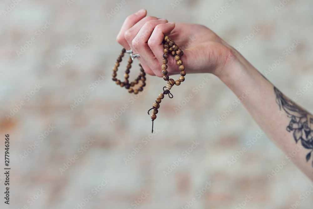 Close up of hands holding wooden necklace
