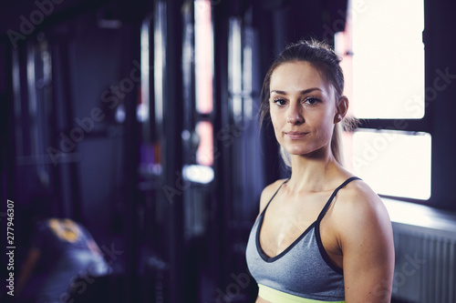 Portrait of young attractive woman at the fitness centre photo