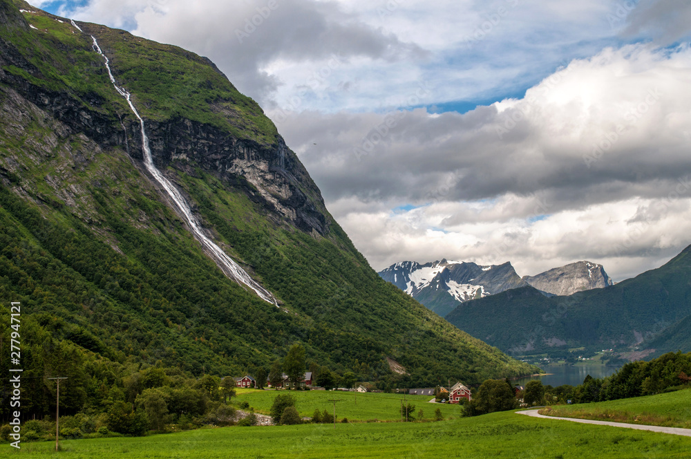 A deep valley in Norway with an infinitely long waterfall