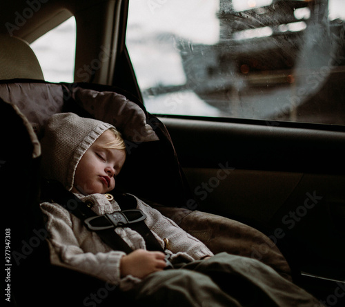 Toddler sleeping in carseat in back of car