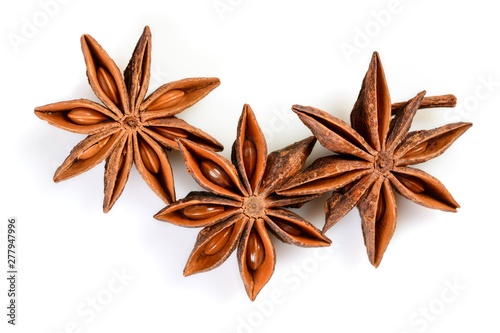 Fototapeta Naklejka Na Ścianę i Meble -  Star anise. Three star anise fruits. Macro close up Isolated on white background with shadow, top view of chinese badiane spice or Illicium verum.