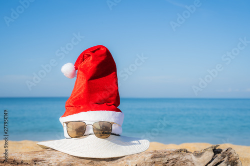 Concept christmas Santa hat on the beach and tree. are texture Nature background creative tropical layout made at phuket Thailand