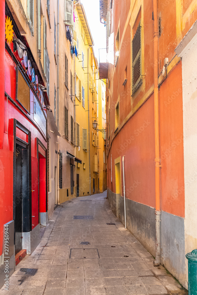 Fototapeta premium Typical district in Nice, with a narrow street and colorful facades