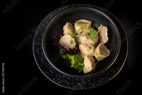 top view of steamed meat dumplings with salad in deep bowl