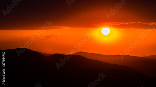 A wonderful sunset in the mountains. Orange sky and dark silhouettes of mountains. Carpathian Mountains landscape. Bieszczady. Poland © Szymon Bartosz