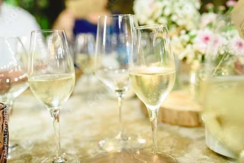 Several glasses with bubbly and fresh champagne served on the table of a banquet.