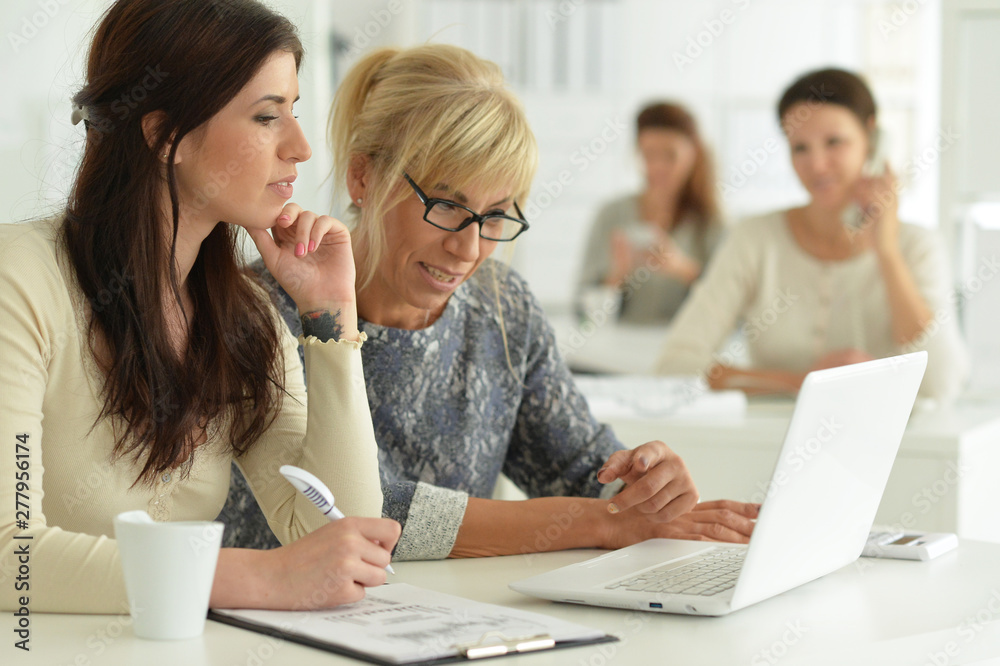 Portrait of women working together in office Portrait of women working together in office