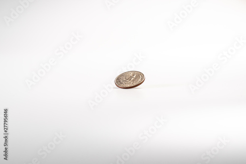 Dollar coin rotating on white background, concept of American economy.