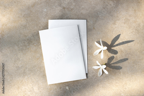 Blank greeting cards, invitations mockups with white Carissa flowers. Marble backgound with tree leaf shadow overlay. Modern template. Wedding stationery. Summer, vacation design. Flat lay, top view. photo