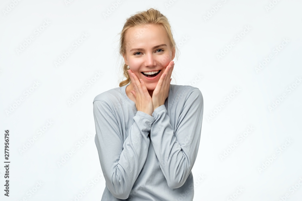 Excited surprised amazed blonde woman open mouth feels astonishment touch face with hands. Girl is kucky to hear great news. Passed an exam concept. Positive facial emotion. Excited surprised amazed blonde woman open mouth feels astonishment touch face with hands. Girl is kucky to hear great news. Passed an exam concept. Positive facial emotion.