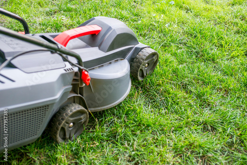 Mowing a lawn with a lawn mower. Lawn mowers cut grass. Garden work concept background
