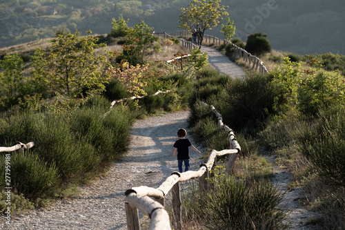 Boy walking in a path with mountains around, Colli Euganei photo