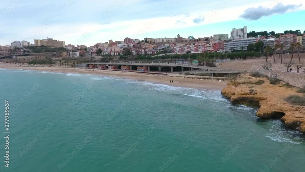 Aerial view of Tarragona beach in winter. Dog walking on the beach