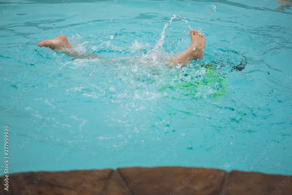 Kids Splashing and Swimming Underwater in a Pool
