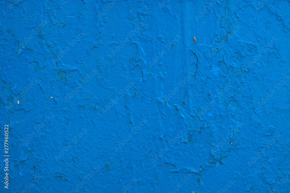 The texture of the iron metal painted blue paint shabby old shabby scratched cracked ancient metal sheet wall. The background The texture of the iron metal painted blue paint shabby old shabby scratched cracked ancient metal sheet wall. The background