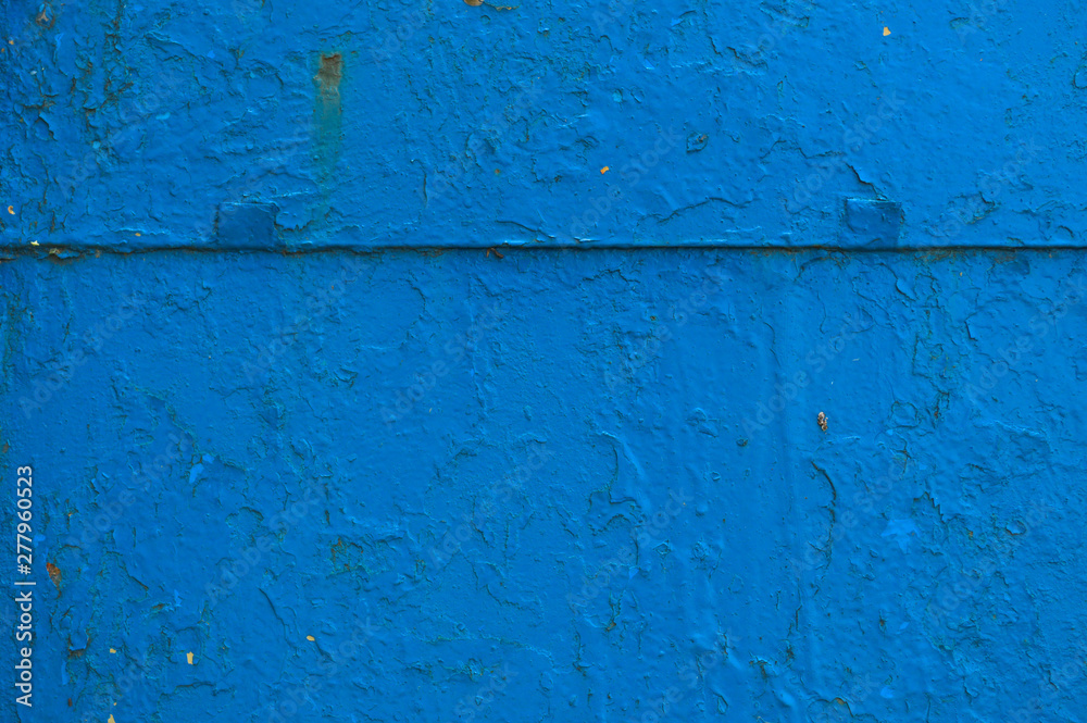 The texture of the iron metal painted blue paint shabby old shabby scratched cracked ancient metal sheet wall. The background The texture of the iron metal painted blue paint shabby old shabby scratched cracked ancient metal sheet wall. The background