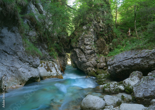 CLOSE UP  Stunning crystal clear river water flows along the rocky riverbed.