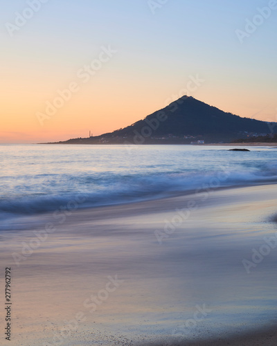 Sunset at the Moledo beach  with a mountain on backgroud