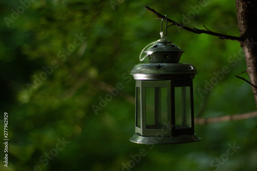 Lamp for candles, silver color, decoration items, nature background, river, color transparent stones, place for text © Artur Kiselev