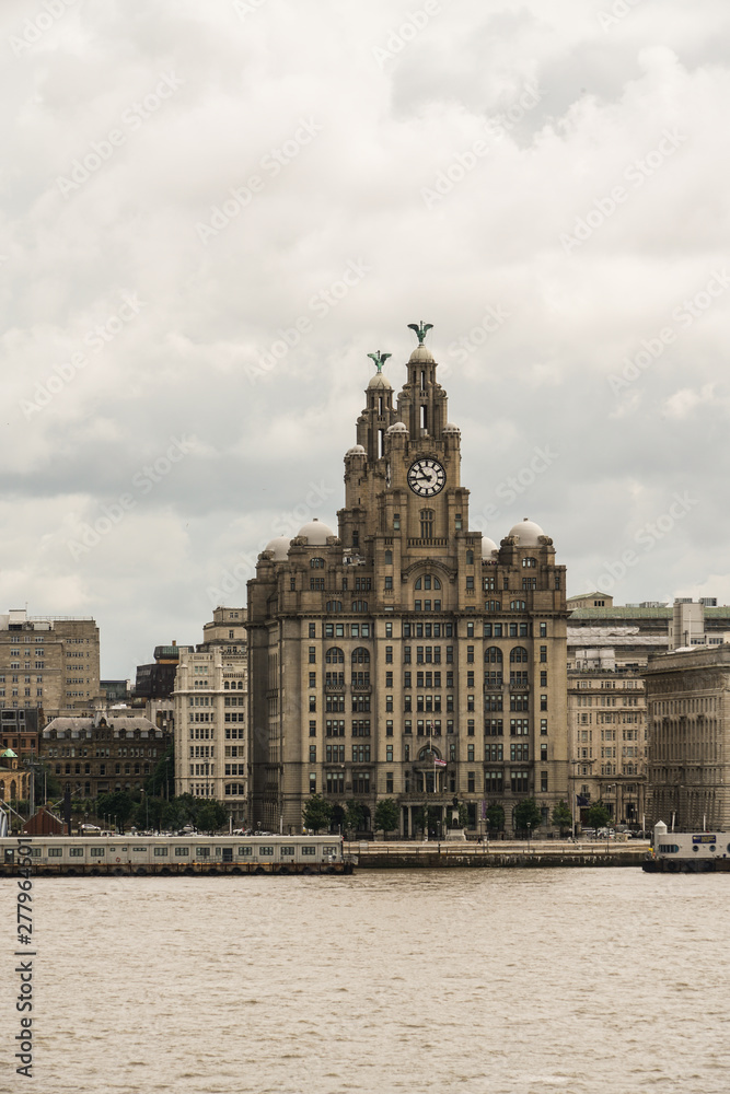 Royal liver building view in Liverpool from ferry in a cloudy summer day