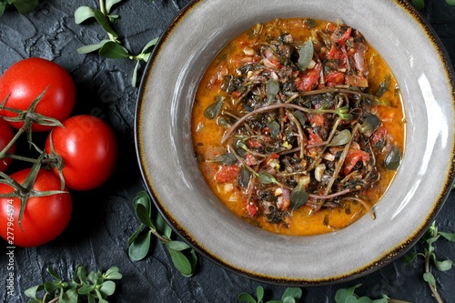dish of purslane. potulak-edible useful weed. stalks of purslane stewed with tomatoes. Turkish, Greek, Mexican cuisine. eat the weeds, wild food. Omega-3