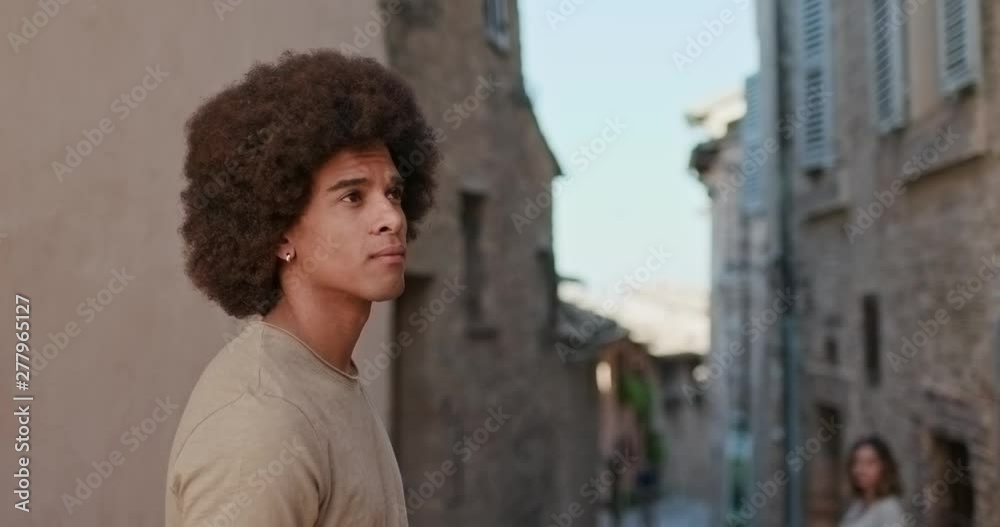 Man looking to woman in small town street. Happy tourist people walking and running through small street visiting rural town of Spello.Friends italian vacation trip in Umbria.4k slow motion Man looking to woman in small town street. Happy tourist people walking and running through small street visiting rural town of Spello.Friends italian vacation trip in Umbria.4k slow motion