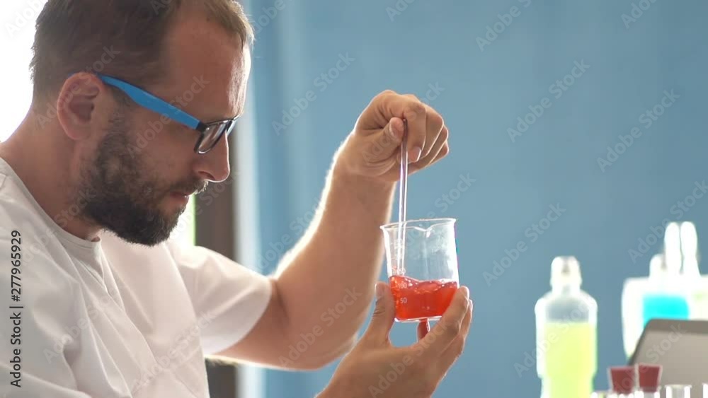 Man scientist doing lab test with chemicals, slow motion Man scientist doing lab test with chemicals, slow motion