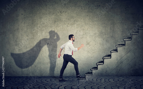 Konstfotografi Super hero business man stepping up on stairs climbing to success