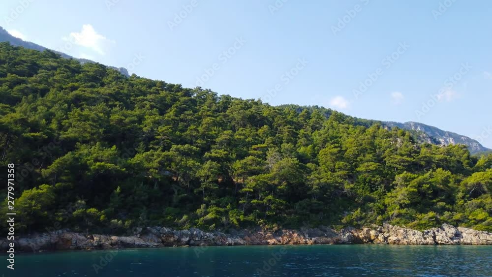 A tracking shot of the idyllic Aegean coast in the summer, from Gulf of Gokova. Shot and presented at 60 fps. A tracking shot of the idyllic Aegean coast in the summer, from Gulf of Gokova. Shot and presented at 60 fps.