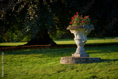 Antique stone garden vase with flowers