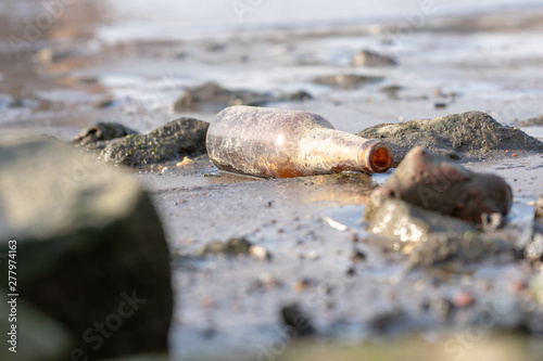 A forlorn brown bottle washed up on the shore