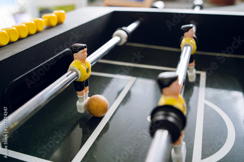 Close up on players of Table football soccer kicker foosball top-table game playing