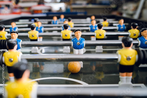 Close up on players of Table football soccer kicker foosball top-table game playing