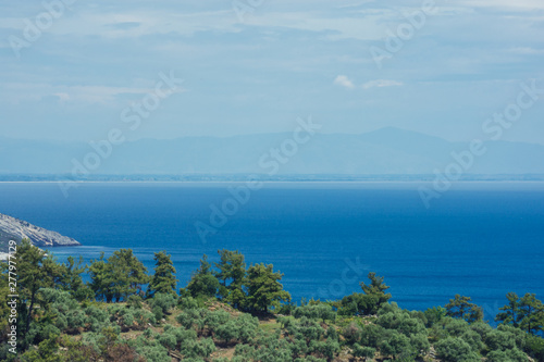 Summer vacation landscape of cloudy sky, mountains, sea and woods