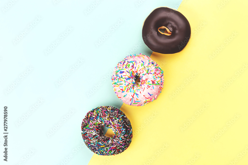 Three tasty doughnuts on turquoise background. Three tasty doughnuts on turquoise background.