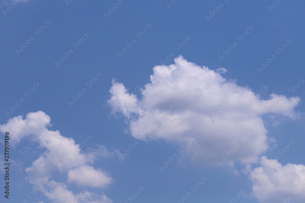 Background of blue sky texture with white fluffy clouds. Horizontal, nobody, place for text. Concept of nature and meteorology.