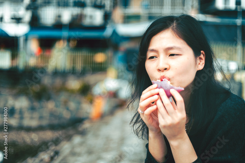 Woman eating traditional chinese sweet sticky rice cake