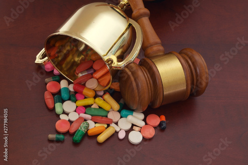 Doping in sport and court of arbitration concept. Gavel, golden cup and drugs 