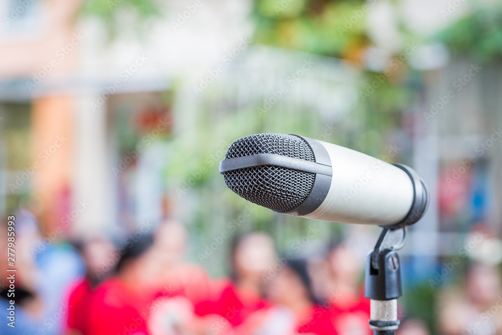 Close up of microphone in public place with blur background Close up of microphone in public place with blur background