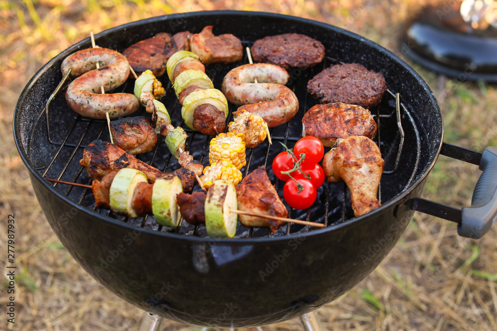Cooking of tasty food on barbecue grill outdoors Cooking of tasty food on barbecue grill outdoors