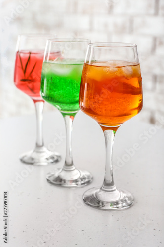 Glasses of tasty summer cocktails on table