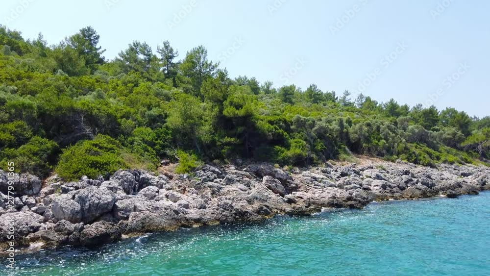 A tracking shot of the idyllic Aegean coast in the summer, from Gulf of Gokova. Shot and presented at 60 fps. A tracking shot of the idyllic Aegean coast in the summer, from Gulf of Gokova. Shot and presented at 60 fps.