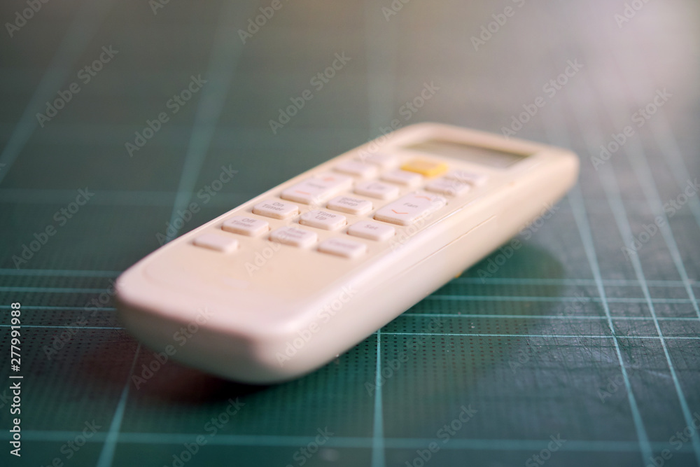 Air conditioner remote on green cutting pads Air conditioner remote on green cutting pads