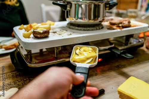 Canvas Print Swiss or Dutch raclette table filled with ingredients for a celebratory evening