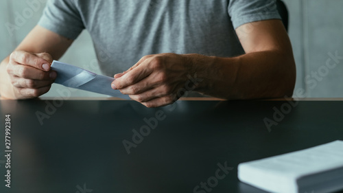 Business correspondence. Cropped shot of man holding envelope  received letter. Copy space.