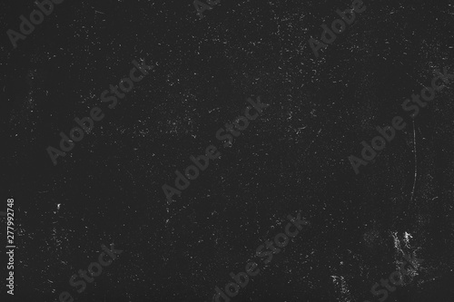 White dust and scratches over black surface. Grainy texture background. Empty space. photo