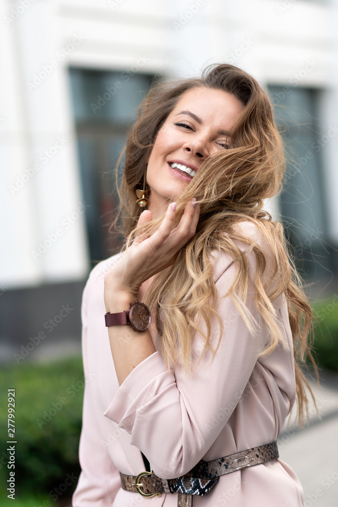 Trendy dressed fashionable girl wearing fur coat. Young pretty beautiful woman with long curly hair looking at you. Trendy dressed fashionable girl wearing fur coat. Young pretty beautiful woman with long curly hair looking at you.